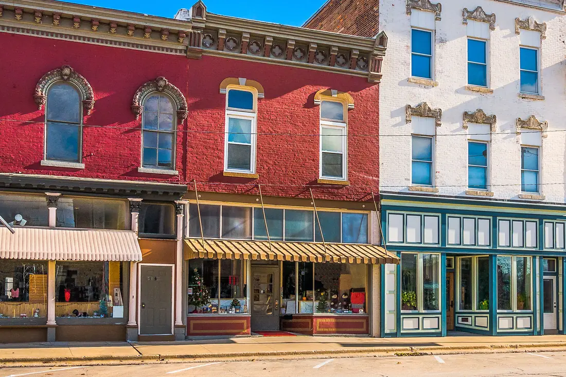 A main street of independent shopfronts, each one somebody's own business.