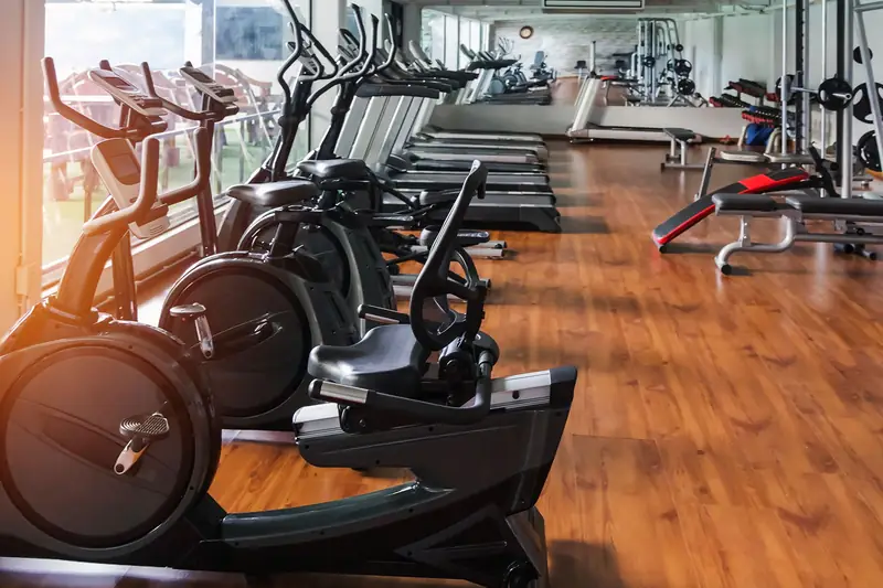 A row of exercise bikes on a gym floor: equipment that earns its own repayments.