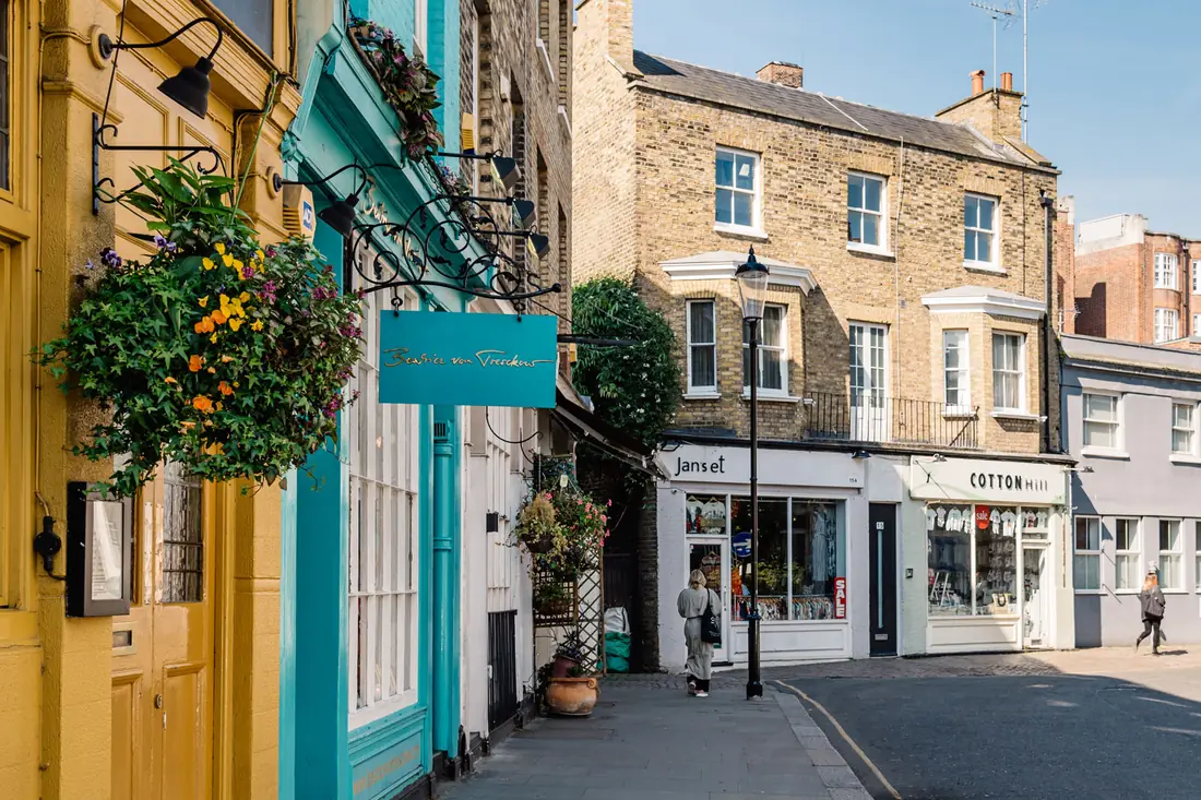 A quiet street of shops in the morning, before the day's decisions.